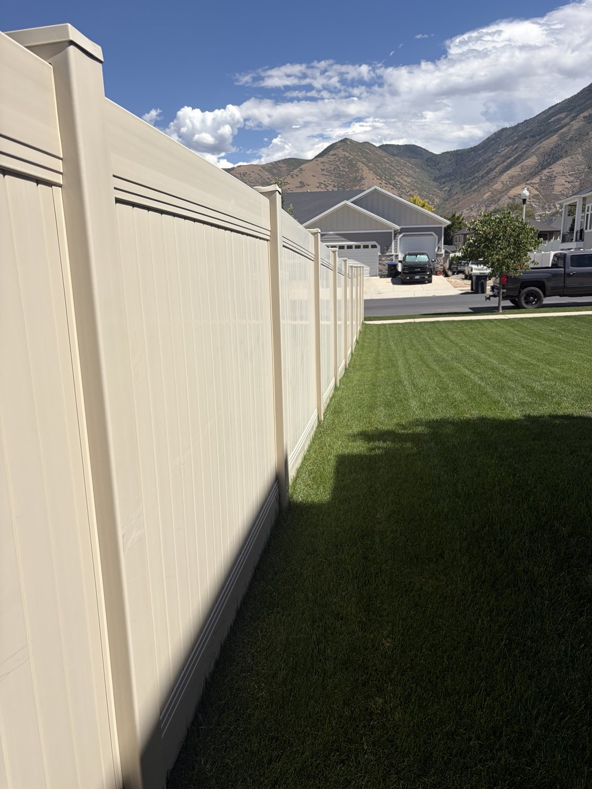 White vinyl privacy fence along a residential yard